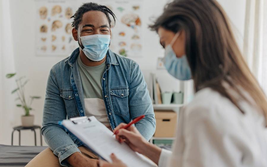 A patient discusses with overall health with his doctor during his annual physical exam.