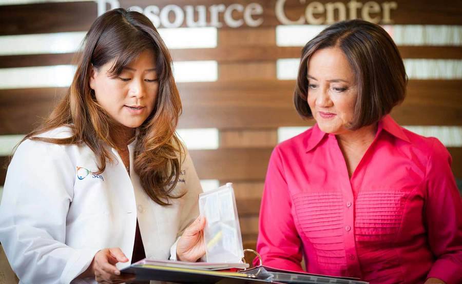 A Scripps oncologist talks with a patient in the Resource Center.