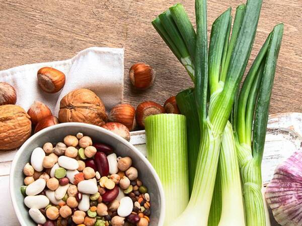 Foods pictured include almonds, walnuts, onions, chickpeas and white beans.