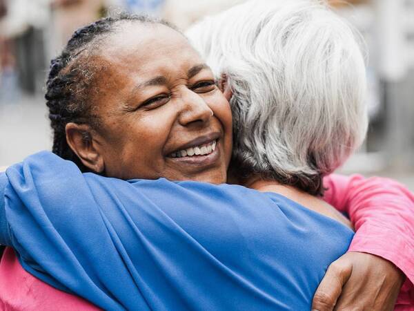 Two women hug who are united via organ donation.