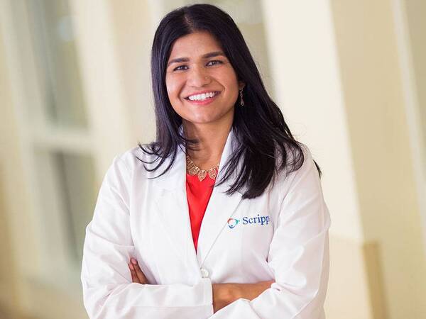 Dr. Poulina Uddin, MD smiling in a white coat smiling as a Scripps doctor.