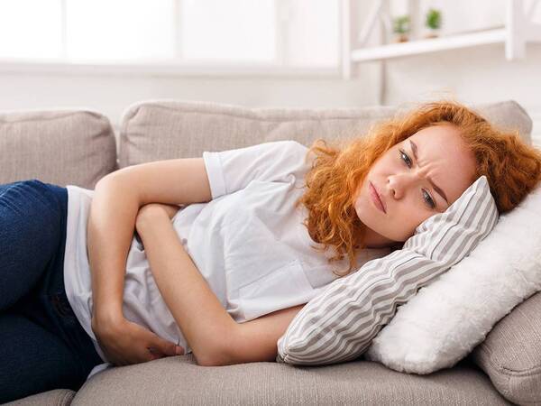 A young woman experiencing stomach problems.