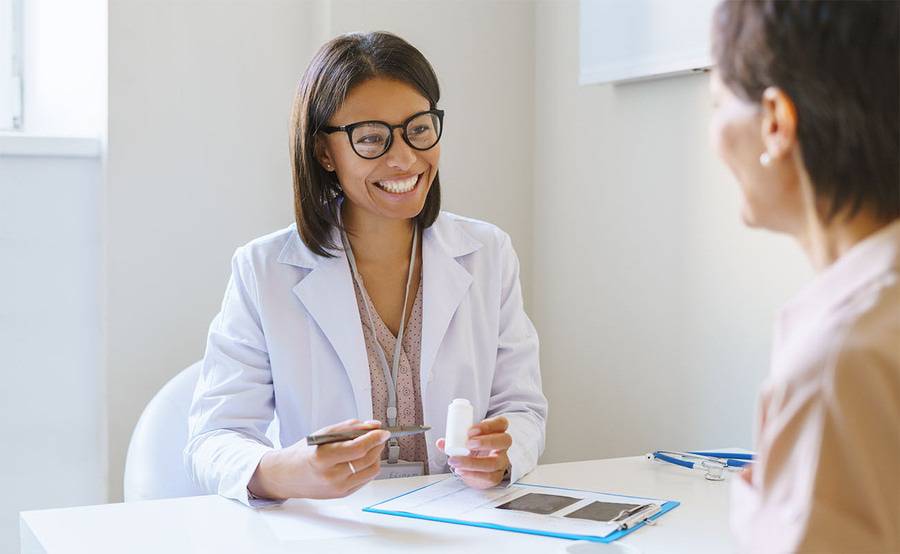A provider sitting with a diabetes patient going over habits and tips to help self manage diabetes.