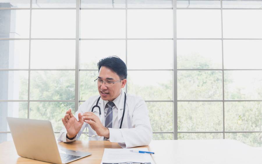 A doctor speaks to a patient during a video call. Virtual care at work.