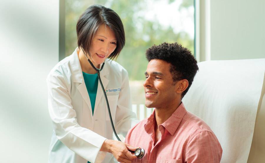 Dr. Siu Ming Geary, MD, Internal Medicine physician for Scripps Clinic treating a patient in a clinical office.