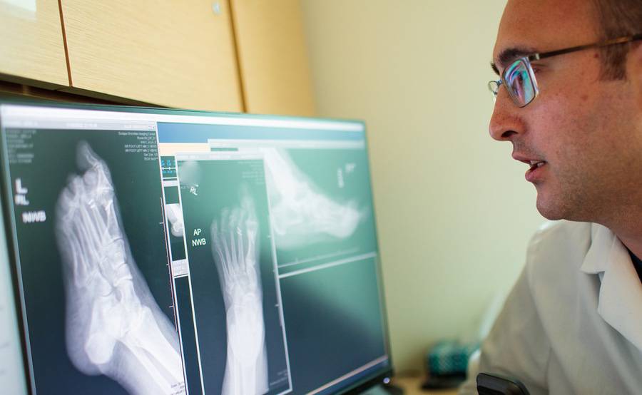 A Scripps foot and ankle physician reviewing a foot and ankle X-ray.