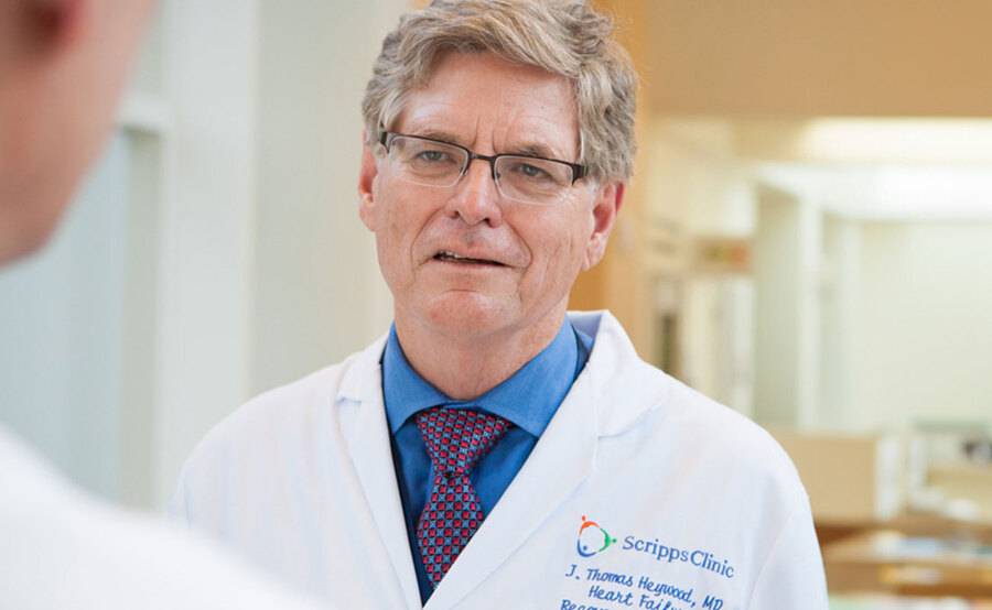 A male doctor in a white coat represents heart failure treatment at Scripps Health.