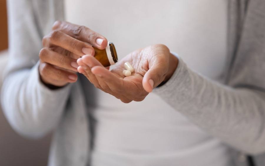 A patient takes heart medications to manage her condition.