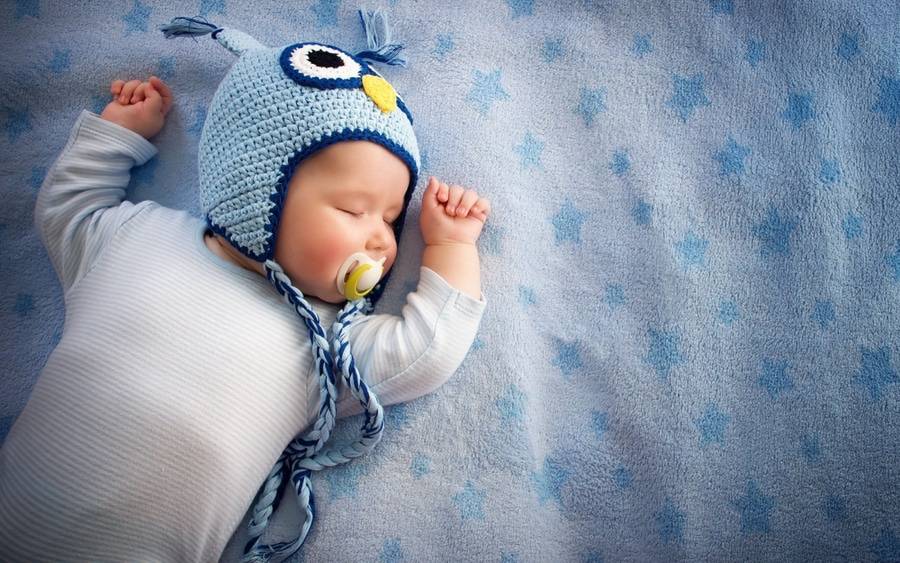 A 2-month-old baby comfortably sleeps.