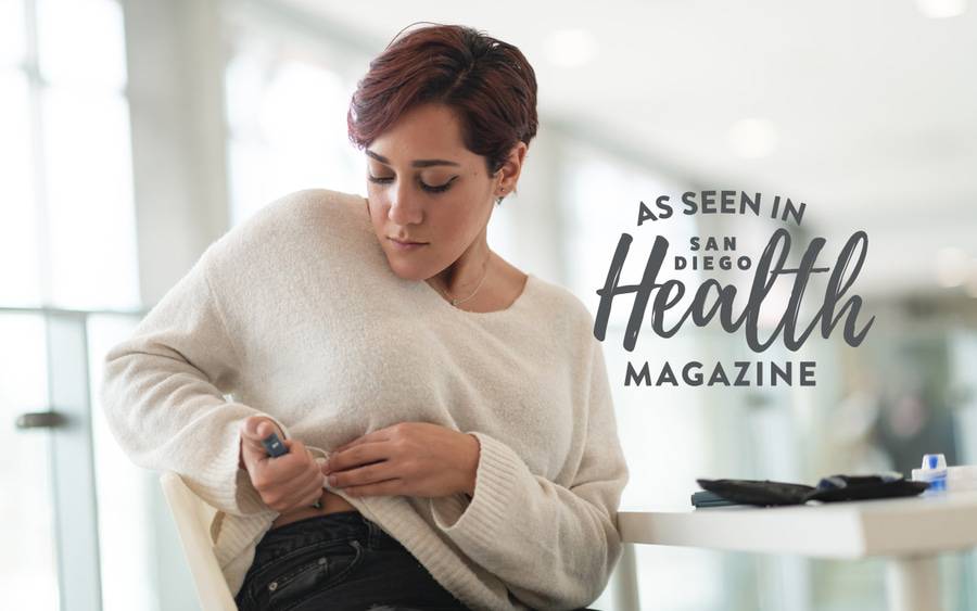 A young woman injects a GLP-1 medication in her waist to help with weight loss. San Diego Health Magazine
