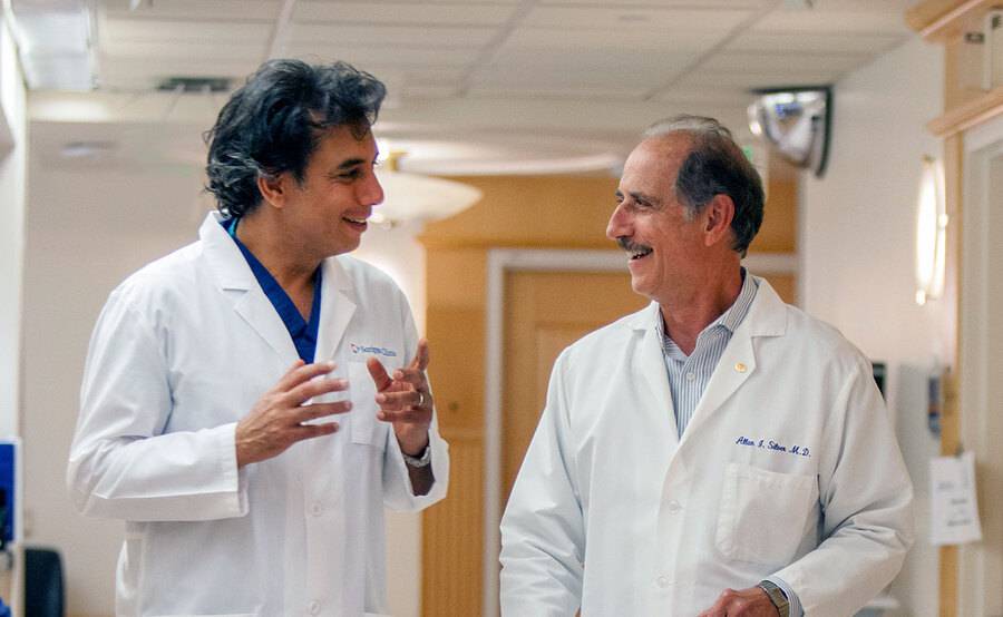 Perinatologist Dr. Sean Daneshmand walks down the hallway with obestetrician Dr. Allan Silver.
