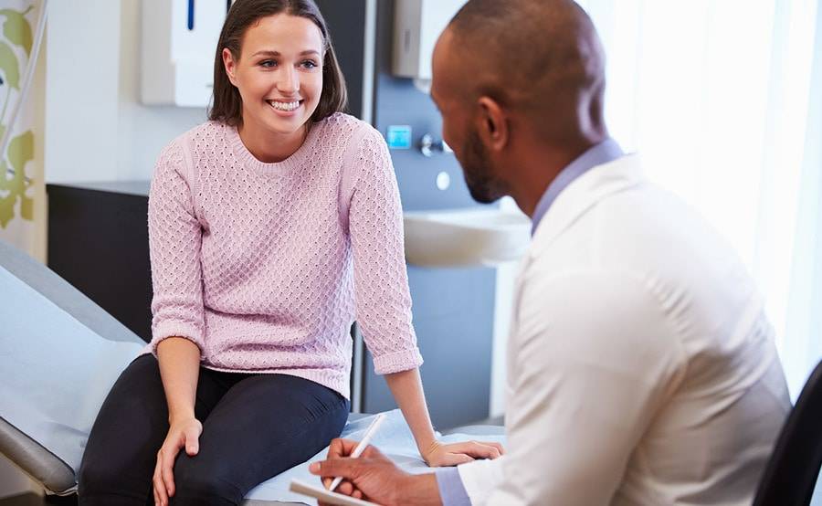 A resident from the Scripps Encinitas Podiatric Residency Program examines a patient.