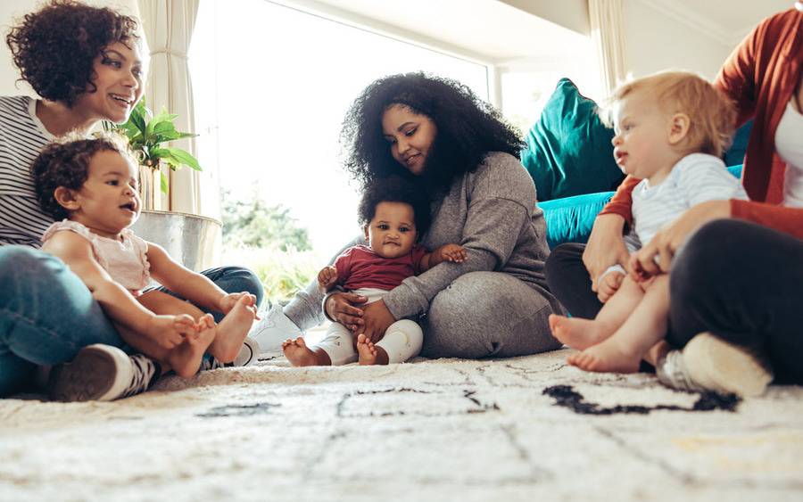 A diverse group of mom and babies participate in an exercise class designed to strengthen mom's pelvic floor after childbirth.