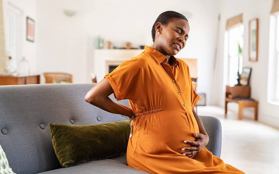 A pregnant woman experiences lower back pain.
