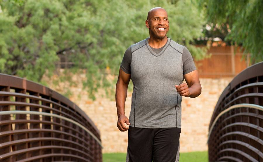 A middle-aged black man exercises while representing what every man should know about prostate cancer.