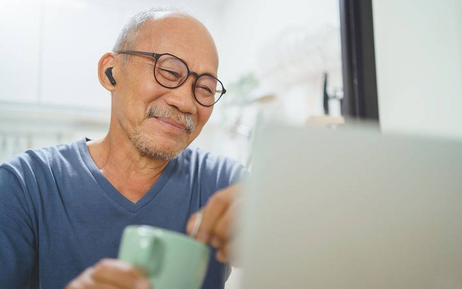 Man viewing a webinar on computer screen