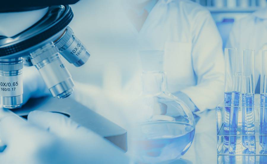 A physician amidst lab equipment related to the Scripps Health/Scripps Clinic Bio-Repository and Bio-Informatics Core.