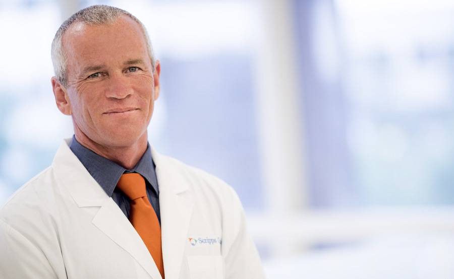 Scripps Clinic cardiologist Douglas Gibson, MD, smiles in a hospital setting and represents the best heart care in San Diego.