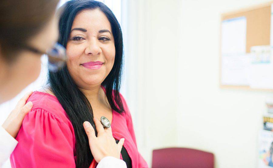 A nurse practitioner listens to a woman’s heartbeat, representing the kind of care available at Scripps HealthExpress, a walk-in clinic in Chula Vista.