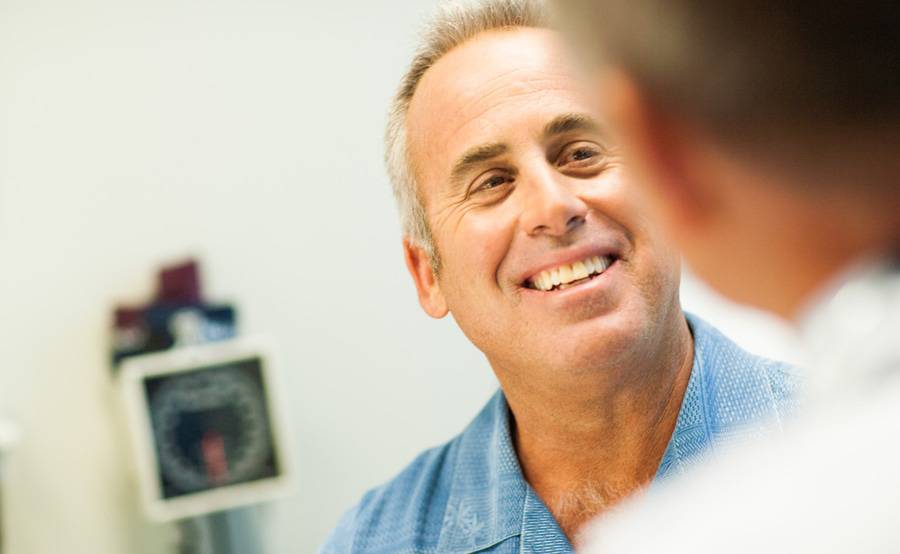 A middle-aged man meets with a nurse practitioner at a Scripps walk-in clinic, which offers care for minor illnesses and injuries.