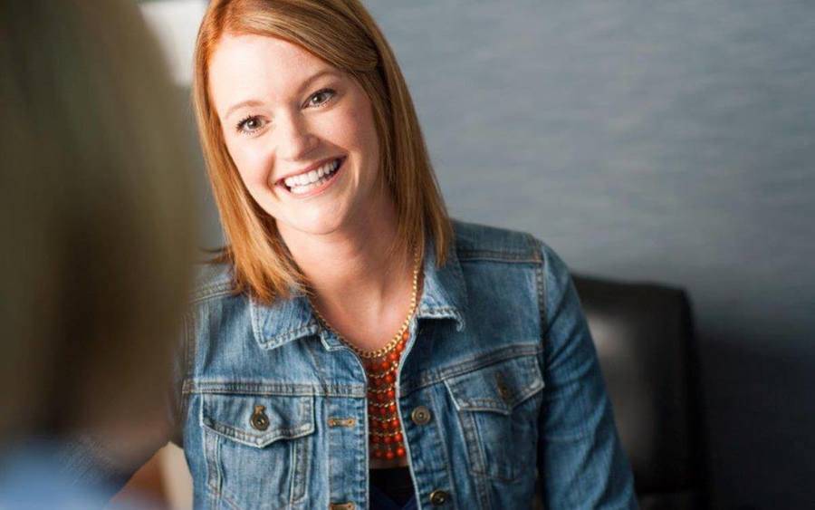 A woman smiling while talking to a Scripps HealthExpress Encintas provider.