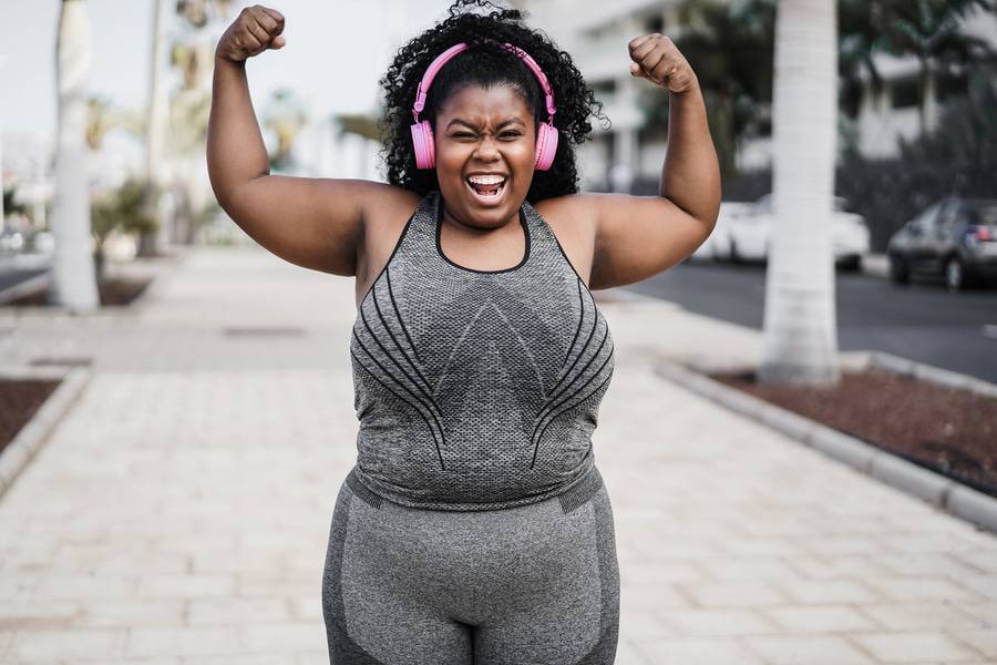 A young woman who underwent gastric sleeve surgery celebrates her success during recovery.