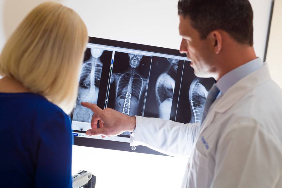 Dr. Gregory Mundis, Orthopedic Surgery, Scripps Clinic going over x-rays with a patient, illustrating the close doctor-patient relationships that are formed.