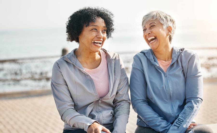 Two senior women laugh outdoors representing the expert stroke care at Scripps.