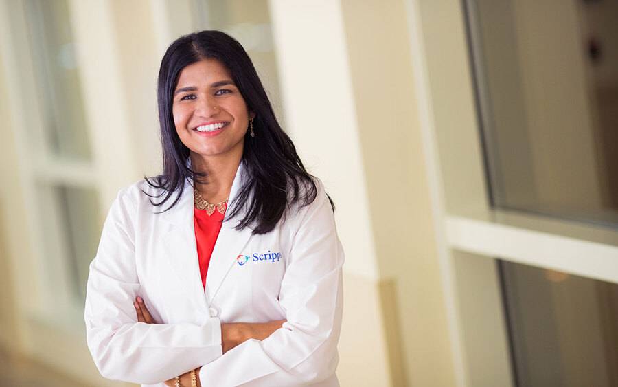 Poulina Uddin, MD smiling in a Scripps Health lab coat.